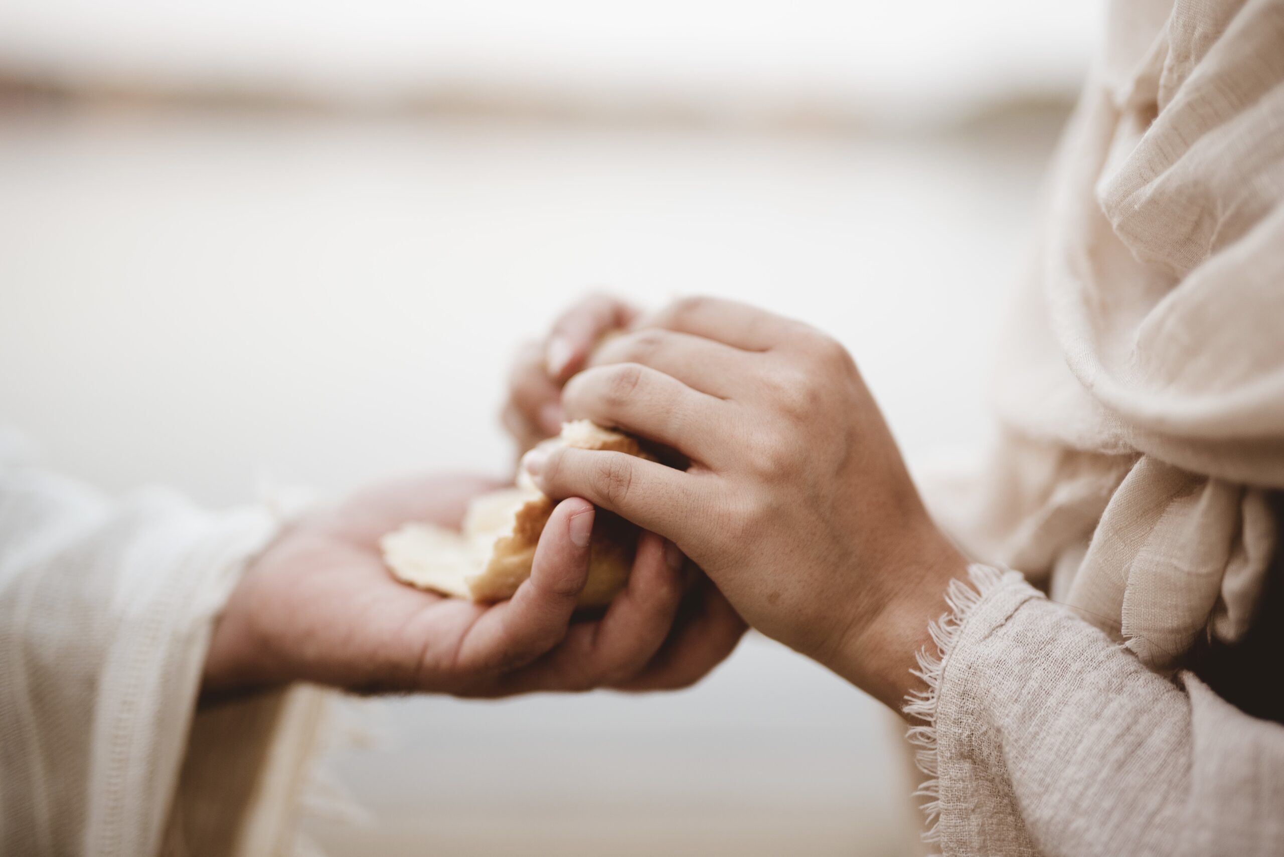 Biblical Scene Of Jesus Christ Handing Out Bread Wit Ha Blurred Background